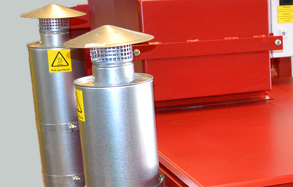 Detail view of the DISAB PES-6 vacuum unit's twin exhaust silencers with safety labels, illustrating the unit’s noise-reducing and pressure-regulating components for safe operation.